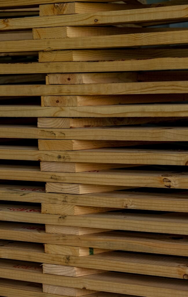 Detailed close-up of neatly stacked wooden planks, ideal for woodworking and construction themed concepts.