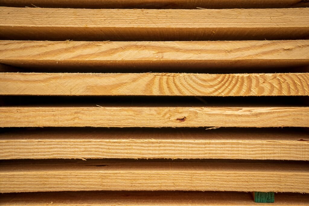 Close-up view of stacked hardwood planks ready for carpentry or construction use.