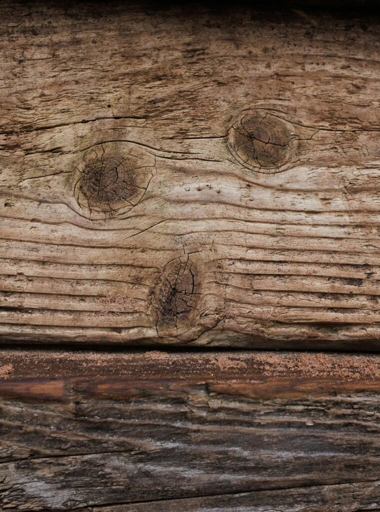 A detailed view of weathered wooden planks showcasing knots and grain texture.